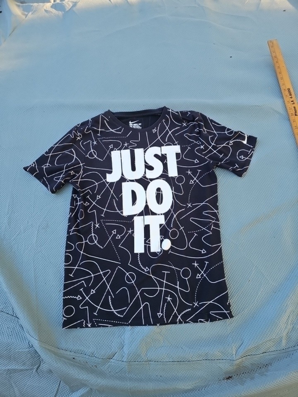 Nike Black Football Pattern Tee with White 'JUST DO IT.' Graphic